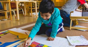 Montessori Program Kindergartener Doing A Map Activity