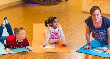 Children and Instructor Practicing Yoga During School Day Enrichment Program
