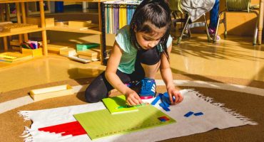 Montessori Program Elementary Student Doing A Math Activity Independently