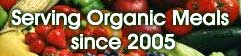 The words serving Organic Meals Since 2005 with a bunch of veggies in the background.