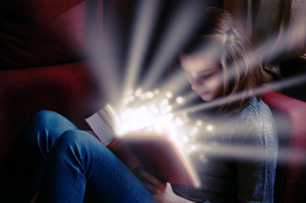 Montessori Elementary Student Reading An Illuminating Book