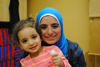 A loving mother and her little girl smiling.