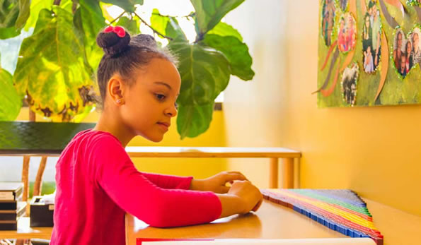 Elementary Montessori School Student Creates Color Transition With Stacking Cubes