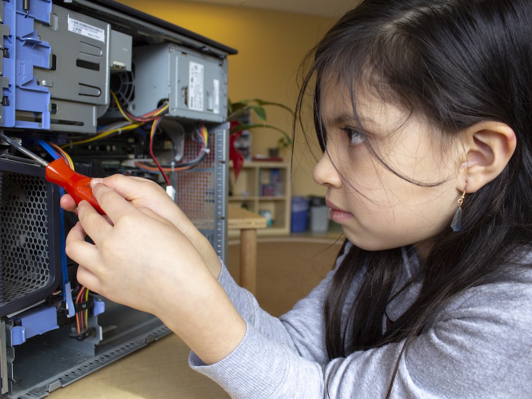 Makerspace Project Disassembling A Personal Computer Chassis - Screwdriver In Hand