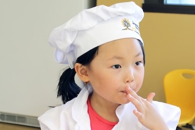 A Camper Eating Freshly Baked Egyptian Flatbread That The Team Made